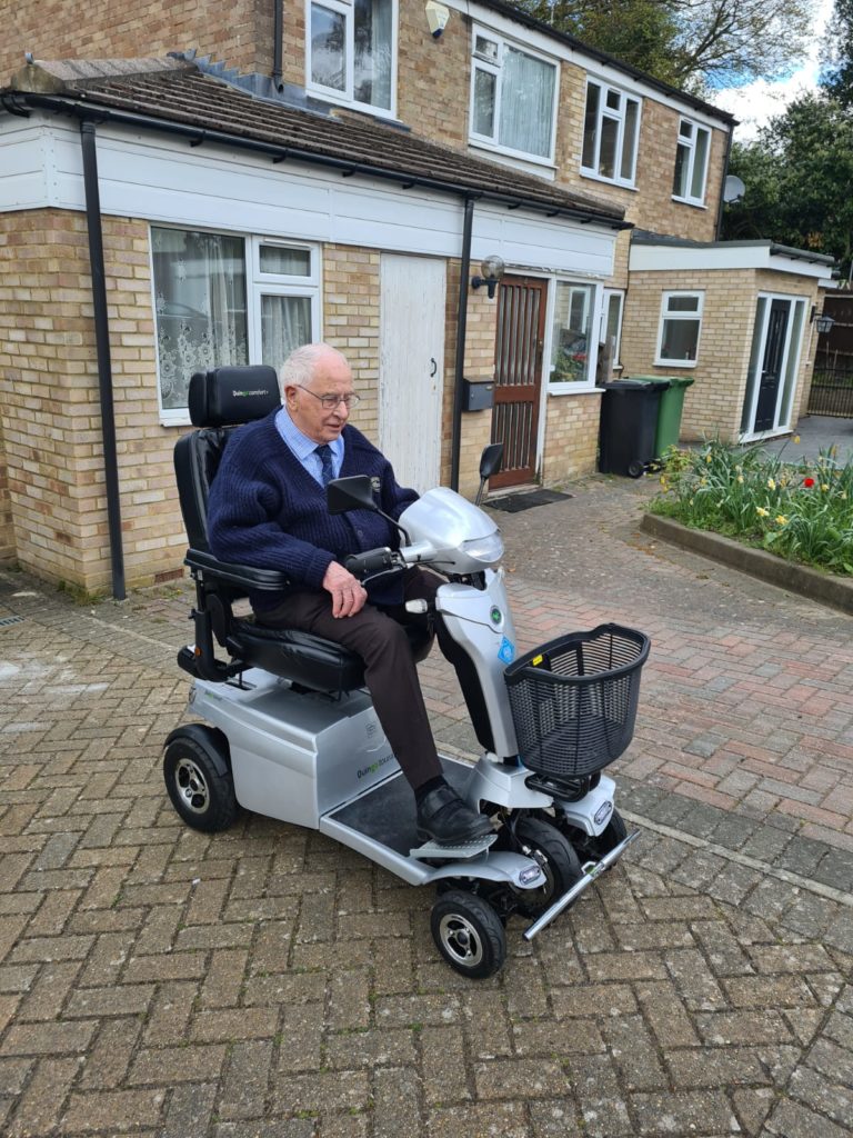 Mr Cook on the Toura two Quingo mobility Scooter