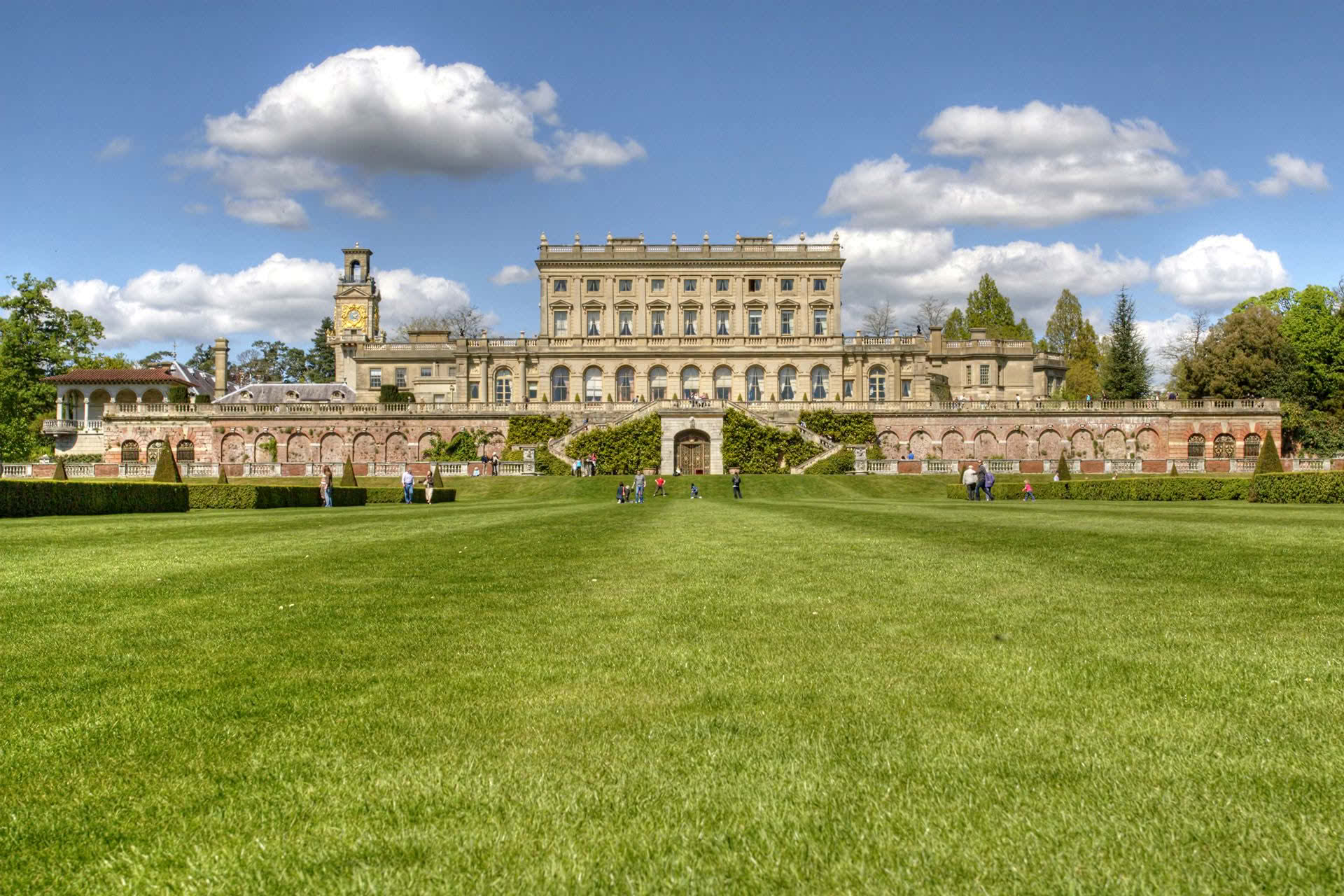 A large building behind a green field
