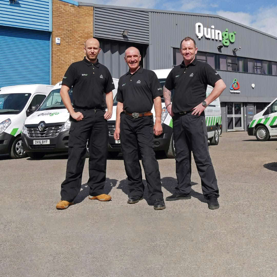 Quingo staff members stood near Quingo vans