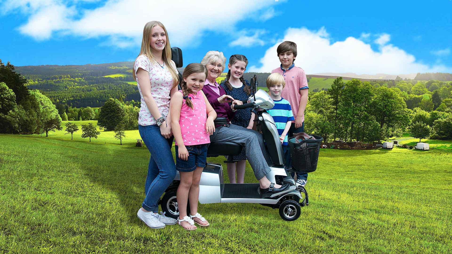 A family on a field with a scooter